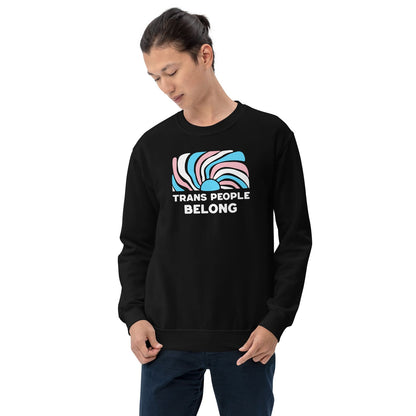 Person wearing a black sweatshirt with 'Trans People Belong' text and rainbow design on a white background