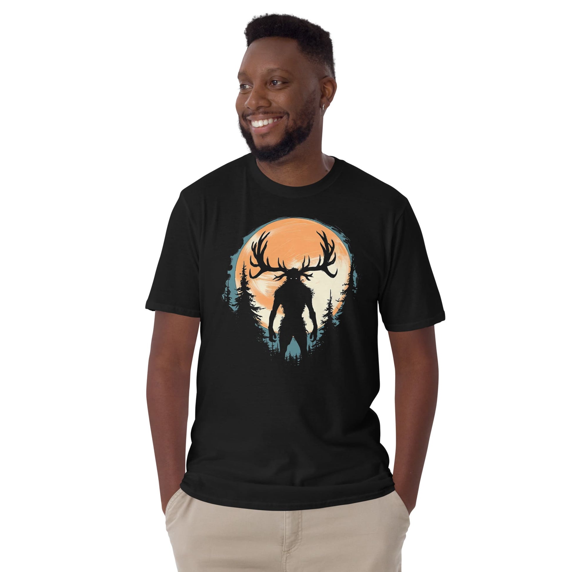 Man wearing a black t-shirt with a graphic design of wendigo silhouette against a sunset sky.