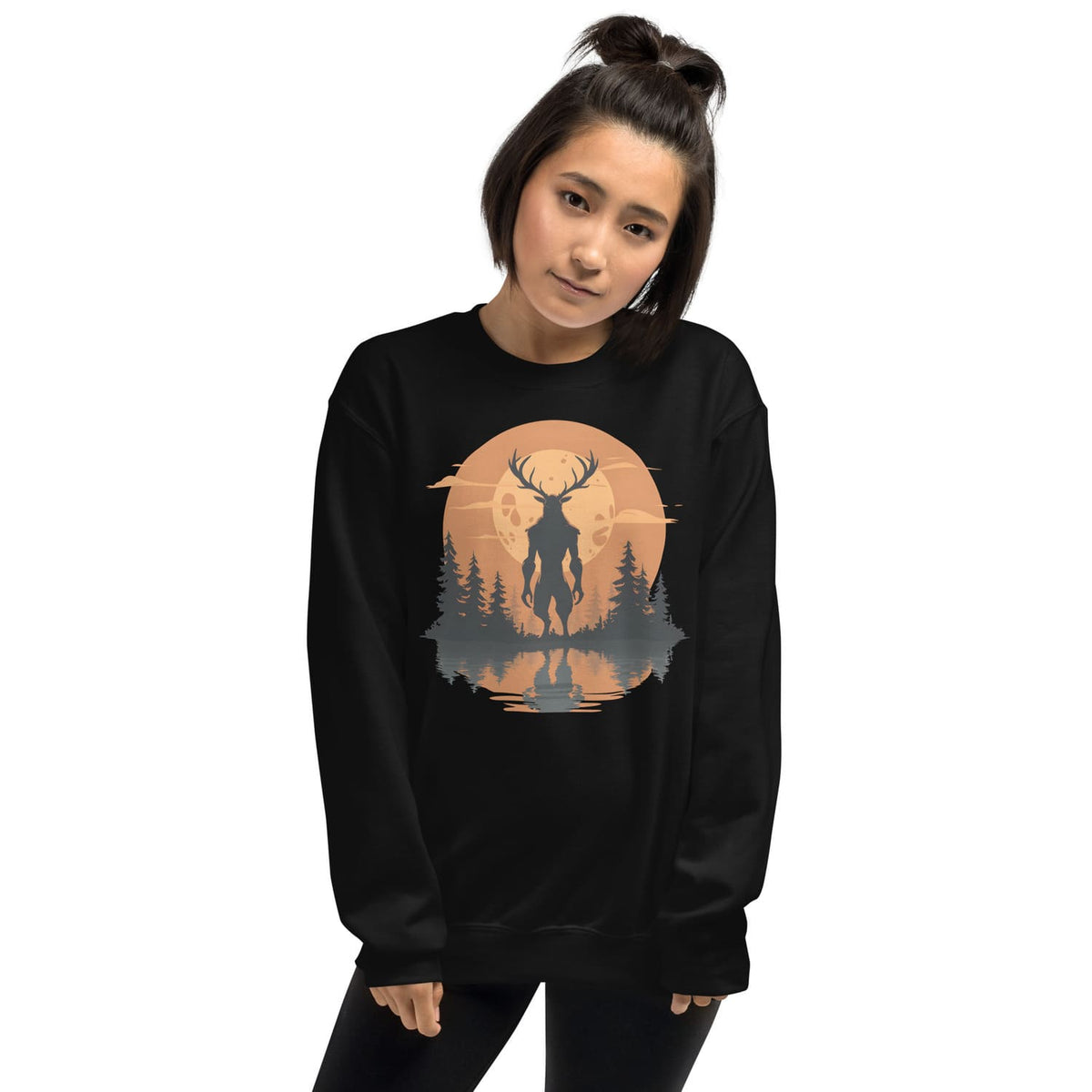 Person wearing a black sweatshirt with a graphic design of a wendigo silhouette against a sunset sky.