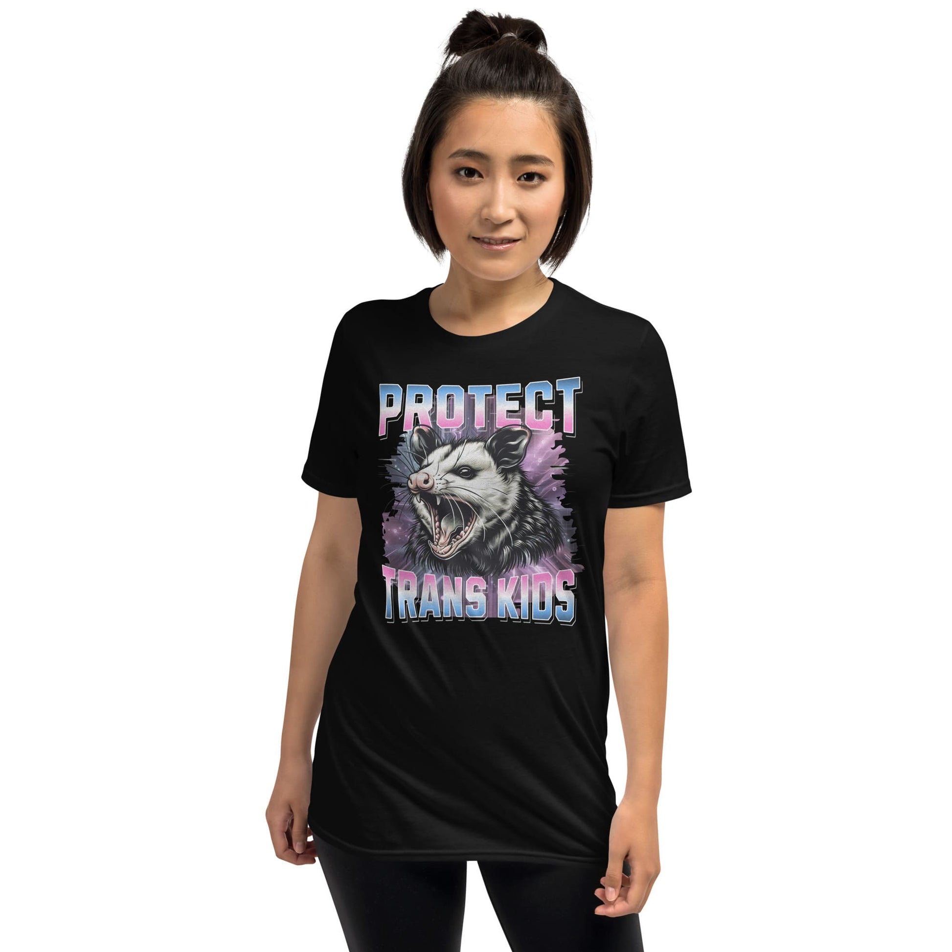 Person wearing a black trans pride t-shirt with a graphic design and text on a white background