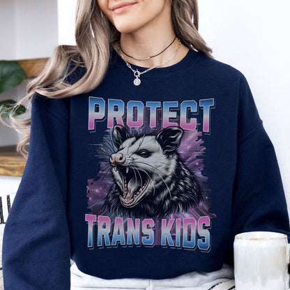 Person wearing a navy sweatshirt with an opossum graphic and text 'PROTECT TRANS KIDS'.