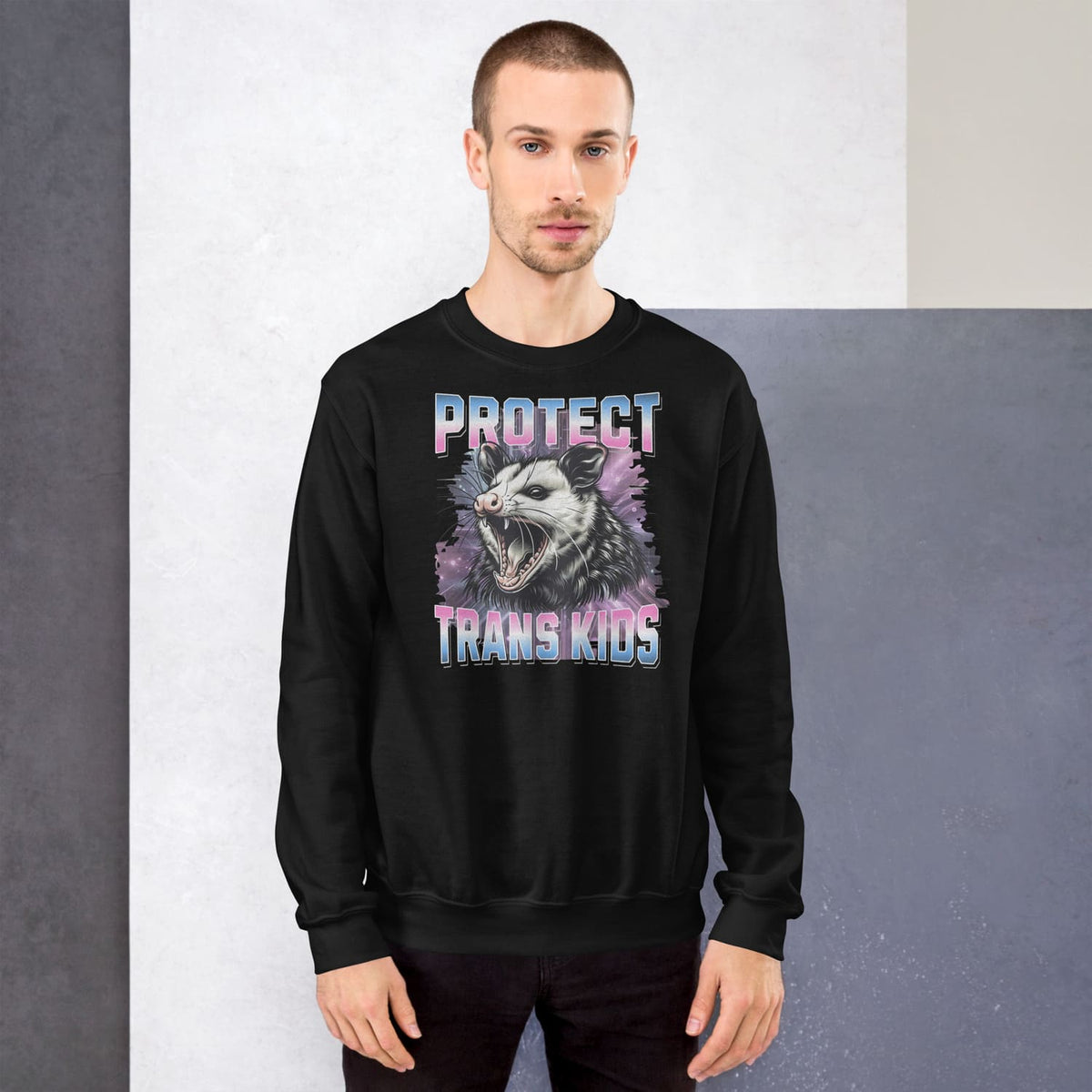 Person wearing a black trans pride sweatshirt with a graphic design and text.