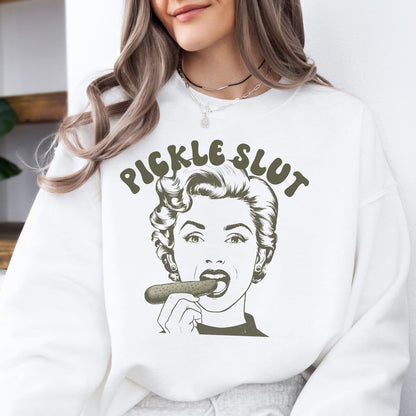 Person wearing a white sweatshirt with a graphic design of a woman eating a pickle and the text 'Pickle Slut'.