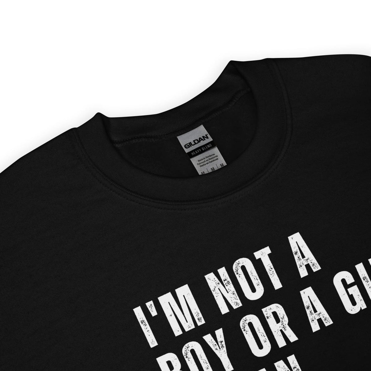 detail of enby sweater with text 'I'm not a boy or a girl' on a white background
