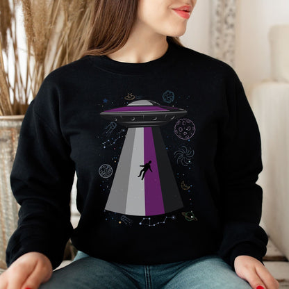 Person wearing a black asexual sweatshirt with a UFO design