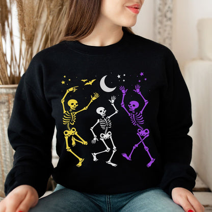 Person wearing a black sweatshirt with enby skeleton designs.
