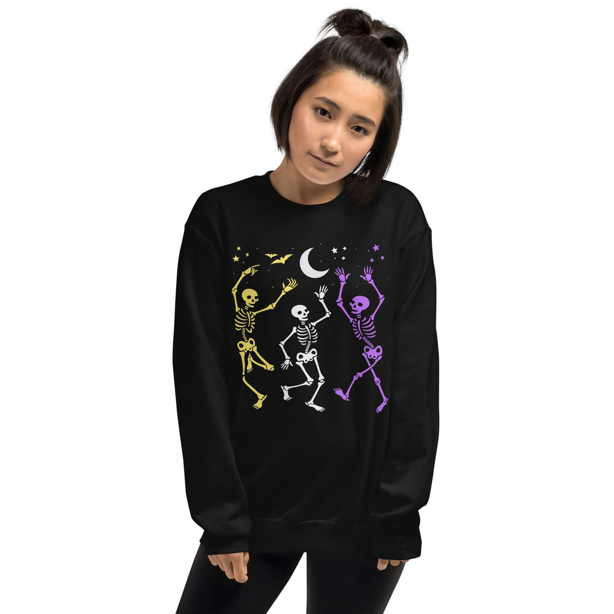 Nonbinary Person wearing a subtle pride sweatshirt with colorful skeleton designs on a white background