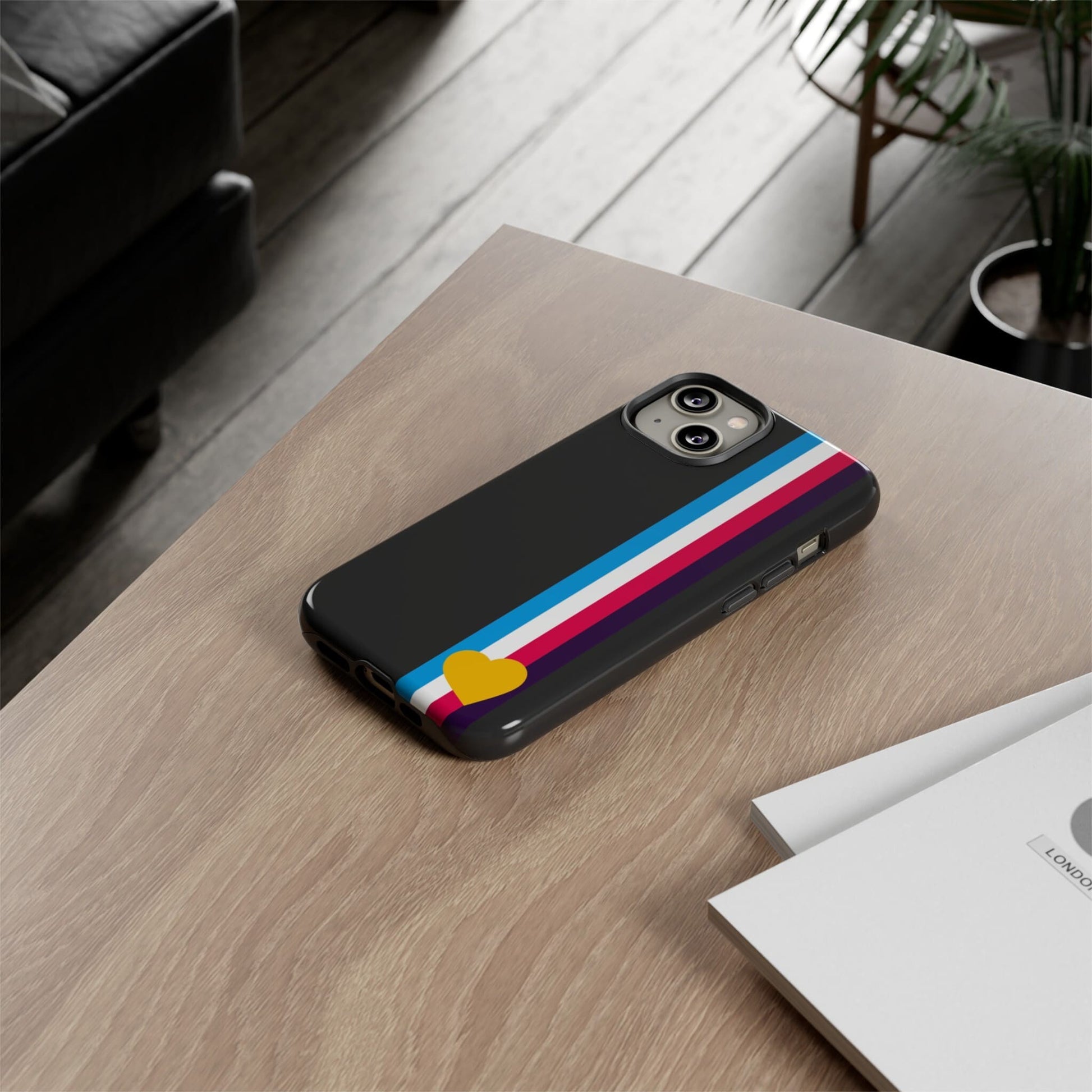 tricolor polyamory phone case, on table